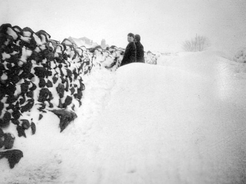 LP Snowdrift with boys.jpg - Two boys in deep snow drifts at Long Preston - possibly the school in background - thought to be  the winter of 1940.  ( Might be Robert Slater & George Carr - Can anyone confirm the names, view & date ? ) 